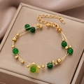 Double-layered gold bracelet with green beads and a central turtle charm pendant - Gold Double-line Green Bead Turtle Bracelet (6345)