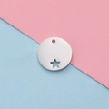 Close-up of polished stainless steel round pendant with star cutout on pastel background - 10mm / Steel