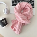 Close-up detail of pink cable-knit wool scarf texture with elegant twist pattern weave - Pink