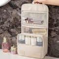 Portable beige hanging toiletry bag with clear compartments and hooks for cosmetics - Beige
