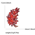 Detailed view of red rhinestone leaf brooch with dimensions 7.2cm by 4.6cm and 21g weight - Antique Gold Red