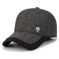 Dark gray knitted winter baseball cap with ear flaps and black brim at 45-degree angle - Light Grey With Shield Label