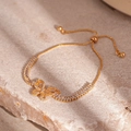 Detailed shot of gold butterfly bracelet featuring zircon stones and adjustable slide clasp - Butterfly Slider Bracelet / Gold
