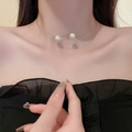 Close-up of a double-layer silver choker necklace featuring two elegant white pearls - Silver