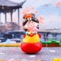 Cartoon Tang Dynasty lady tumbler figurine in yellow top and red base with pink flower - Tang Dynasty Maiden with Lotus Small