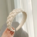 Detailed close-up of handmade cream braided wide headband with silky woven texture - Beige