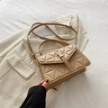 Elegant beige quilted crossbody bag with a metallic clasp on a soft neutral background - Khaki