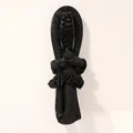 Detail of black heatless hair curler set with satin roller, claw clip, and scrunchies - Rubber Stick Black (1 Curler + 2 Scrunchies + 1 Clip)