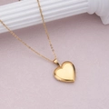 Golden heart locket necklace made of stainless steel displayed on a purple background - Gold Polished Heart (29*29mm)
