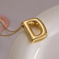 Golden puffer letter D pendant necklace on a sleek snake chain for women - Letter D