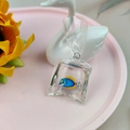 Blue and yellow goldfish in transparent resin water bag pendant on pink display - Style 4 (Blue and Yellow Fish)
