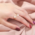 Macro view of gold pearl ring featuring micro-pave zircons on a pink satin fabric - Double Pearl Open Ring