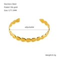 Detailed macro view showing the 18K gold plated heart link on an adjustable steel bangle - Gold