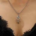 Close-up of a silver punk skull hand pendant on a chain necklace worn by a model - Antique Silver Skull Hand Necklace (11422)