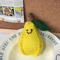 Handmade wool felt pear keychain with a cute smiley face and metallic ring attachment - Yellow Pear