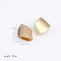 Detailed view of irregular polished gold stud earrings with dimensions 2.3cm by 2.7cm - Gold Irregular Curved Surface Earrings