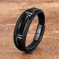 Detail of multi-layer black braided leather bracelet with curved metal bar on wood - 19cm / Black Braided Leather With Black Metal Bar