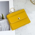 Compact yellow leather coin purse with gold keychain and white decorative stitching - Yellow