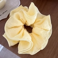Pale yellow oversized scrunchie with subtle plaid texture on a rustic wooden background - Multi-layer Pleated Texture / Yellow