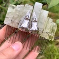 Detail view of natural crystal columns and silver skull charms on a handmade hair comb - Lemon Quartz + Silver Crow Skull