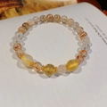 Macro detail of golden rutilated quartz beaded bracelet with metal spacers on a book - 26# Citrine Black Gold Super Seven Crystal Bracelet - Gift Box