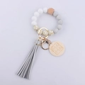 Detail of beaded keychain bracelet with MAMA wooden tag, silicone beads, and leather tassel - Silver Grey
