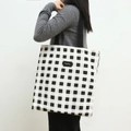 Canvas tote bag featuring classic black and white checkerboard pattern and shopping tag - White and Black Grid