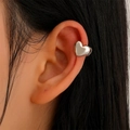 Minimalist silver heart ear cuff clip earrings for women shown on a model ear - Simple 3D Heart (4086)