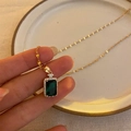 Elegant gold necklace featuring an emerald rectangular crystal pendant with small diamonds - Perfume Bottle Pendant Necklace (249)