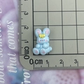 Close-up of a 2cm blue resin rabbit figurine with yellow bow for DIY crafts - Blue Side-Sitting Rabbit