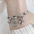 Silver charm bracelet featuring horse and 100 dollar pendants worn on female wrist - Money Pony Style-SL0426