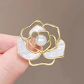 Elegant gold camellia flower brooch with white mother-of-pearl petals and pearl center - Camellia Shell Pearl