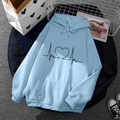 Light blue fleece hoodie featuring black heart-shaped print and drawstring hood - S / Tops / Light Blue