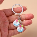 Close-up of cute cartoon food donut keychains with blue and red floral patterns - White and Blue