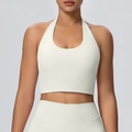 Detail van een ivoorkleurige halter-sportbeha en legging met hoge taille als set - S / Licht Ivoor