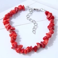 Ethnic style bracelet with irregular red stones and silver lobster clasp on white background - Red