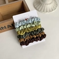 Detail of 6-piece satin scrunchies set in Morandi forest colors on a display card - Forest Gradient (5)
