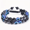 Detailed view of double-layer braided 8mm tiger eye bead bracelet with evil eye charms - Evil Eye + Black Agate + Hematite Bracelet