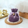 Elegant purple velvet drawstring gift bag with a gold heart charm and silk ribbon bow - Violet+Heart