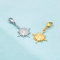 Detail of sunburst pendant charms in gold and silver finish with lobster clasps - Eight-Pointed Star / Steel