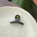 Close-up of translucent dark green acrylic hair claw clip with golden metal spring - 5.5cm Butterfly Buckle / Dark Green
