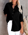 Detail of black cotton linen shirt featuring natural wood buttons and textured fabric - Black