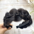 Close-up of black fishtail braided headband showing realistic hair texture and weave - Calico