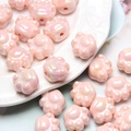 Macro shot of pink pearlescent acrylic cat paw beads for DIY jewelry and crafts - Light Pink