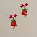 Detail of beaded Christmas bell earrings with red bows and gold metallic accents - Pearl Bow Bell / Earring Hooks