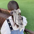 French style hair scarf with butterfly and swan patterns shown on model in a garden - Robin Bird