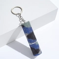 Detail of a cylindrical keychain with blue and black camouflage rhinestone patterns - C13-Blue Camo