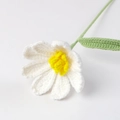 Detailed macro view of white and yellow hand-knitted crochet daisy flower petals - White