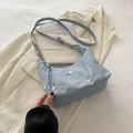 Light blue marbled underarm bag with silver metal butterfly charms and drawstring detail - Blue