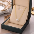Elegant single white pearl pendant on a gold chain inside a luxury green velvet jewelry box - Gold